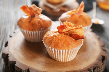 Tasty bacon muffins on decorative stump
