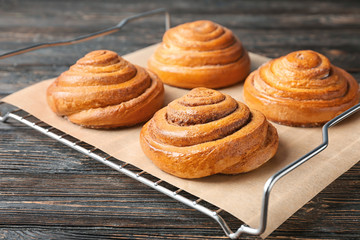 Cooling rack with sweet cinnamon rolls on table