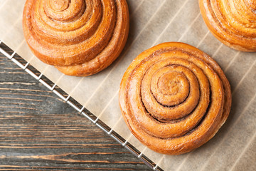 Cooling rack with sweet cinnamon rolls on table