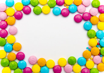 bright candy on a white background spread out in the form of a frame,