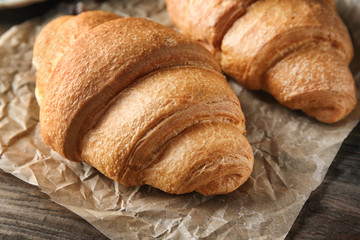 Yummy fresh croissants on wooden table