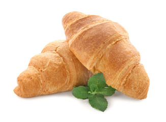 Yummy fresh croissants with mint on white background
