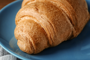 Plate with yummy fresh croissant, closeup