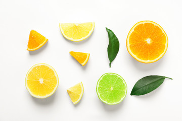 Fototapeta premium Composition with ripe lemon, orange and lime on white background