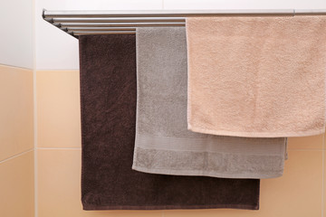 Soft towels drying on rack in bathroom
