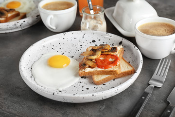 Tasty breakfast with toasts and fried egg on plate, closeup