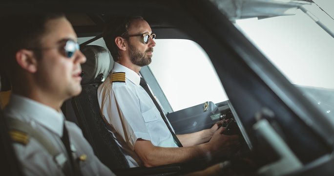 Pilot and copilot flying an airplane