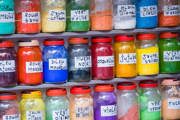 Assortment of glass jars on shelves in herbalist shop on a traditional Moroccan market (souk) in Marrakech, Morocco