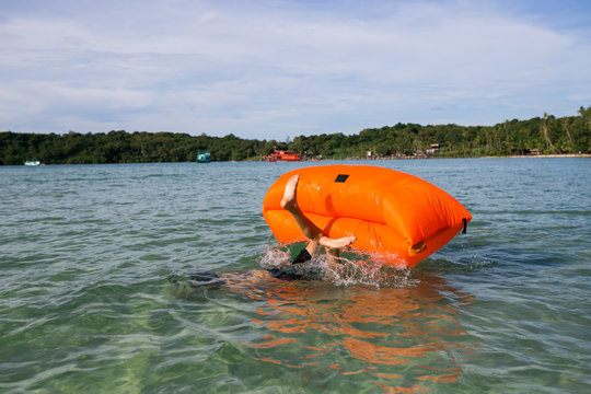 Young blonde man, boy at the beach with Lazy Inflatable Air Bed, hammock, couch camping.  Lounger Sofa Beach Chair Portable Sleeping Bag Mattress. Relax, vacation, travel. Asia. Thailand