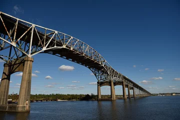 Photo sur Plexiglas Pont Charles Low angle view of the Calcasieu River Bridge against blue skies and clouds, Lake Charles, Louisiana