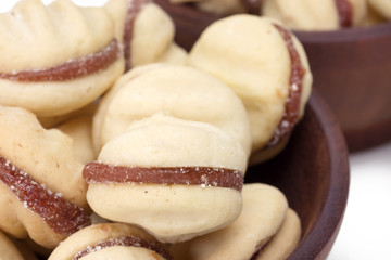Traditional Brazilian guava paste cookies called goiabinha in a wood bowl close