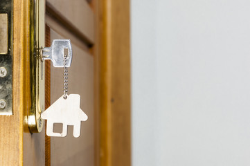 House key with silver chrome pendant with home shape