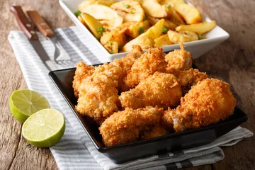  Delicious food: deep-fried chicken wings in breadcrumbs and potato close-up. horizontal © FomaA