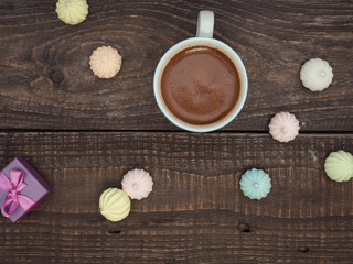 Cocoa with foam and bise on an old wooden table