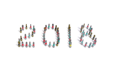 Set of heads for screwdriver (bits) in New year order 2018. Tools collection close up, isolated white background.