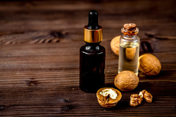 Naklejka premium cosmetic and therapeutic walnut oil on dark wooden background