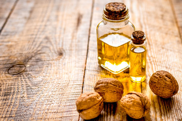 cosmetic and therapeutic walnut oil on wooden background