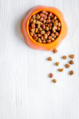 dry pet food in bowl on white background top view