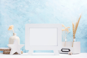White horizontal Photo frame mock up with plants in vase, ceramic decor on shelf. Scandinavian style. Text space