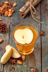 Hot drink of apple tea with cinnamon stick. Hot drink with apples for autumn or winter.