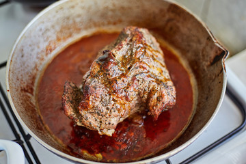 juicy steak in a frying pan, onions and beer