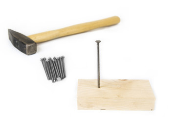 Hammer with nails and wood on white background.