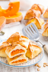 Delicious homemade baking. Patties with fresh pumpkin on white background, closeup