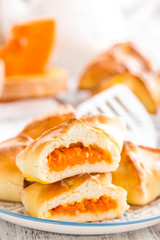 Delicious homemade baking. Patties with fresh pumpkin on white background, closeup