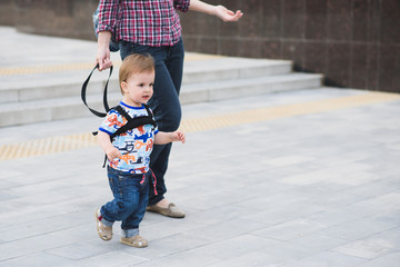 Mom insures her child during a walk