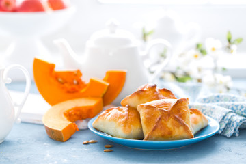 Delicious homemade baking. Patties with fresh pumpkin on white background, closeup