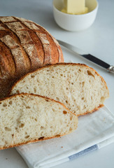 Homemade fresh bread sliced on a white background.