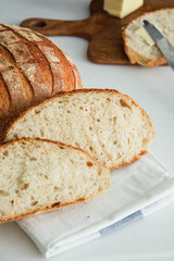 Homemade fresh bread sliced on a white background.