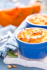 Delicious mini casserole with cottage cheese and pumpkin for breakfast. White background. Closeup