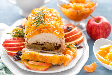 Baked meatloaf stuffed with apples and plums, decorated tangerine confiture. Christmas menu