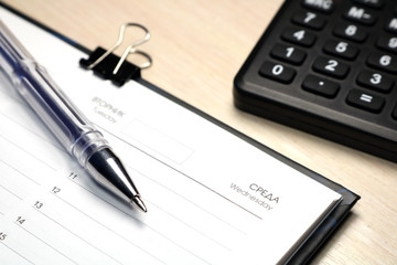 Notepad for notes on a wooden background. Daily log.