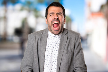 Fototapeta premium Handsome man shouting on unfocused background