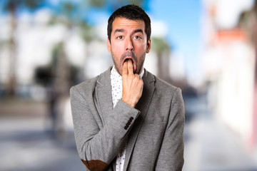 Naklejka premium Handsome man making vomiting gesture on unfocused background