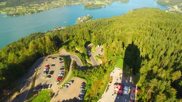 View from PyramidenKogel, biggest woden tower in the world, with 300 ft (100 m), Klagenfurt, Austria, Europe. A view to lake WortherSee and parking near tower. Famous view point place.