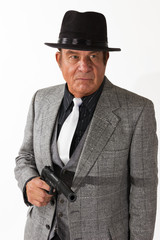 Older Man in Fine Suit on White Background. An older gentleman in a fine suit in front of a plain, white background.