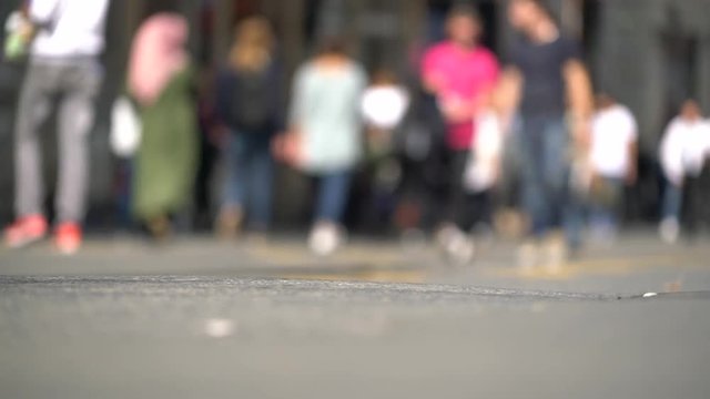 closeup feet of people walking on street