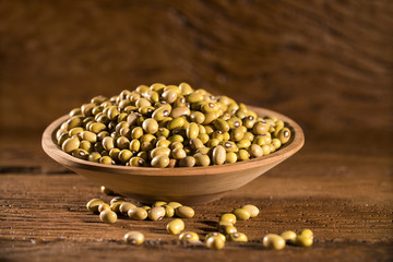 beans into a bowl on wooden background