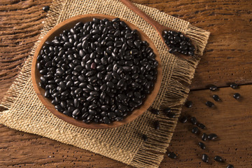 black beans on wood background