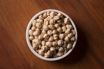 Steamed gold chickpeas in bowl, vegan food.