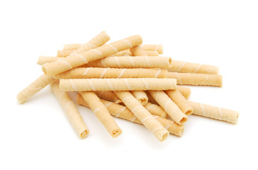 Wafer roll sticks cream rolls over a white background