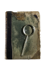 ancient shabby book and a magnifying glass for reading isolated