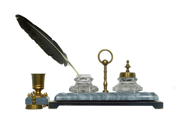 19th century inkstand with a stone base, brass parts and a bird feather sticking from the cut-glass...