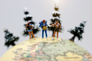 Miniature people, backpackers on the globe walking to destination. travel and business concept.