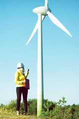 Woman engineer with wind turbine 