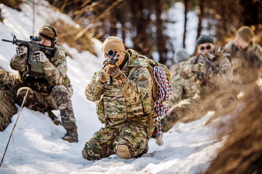 team of special forces weapons in cold forest. Winter warfare and military concept