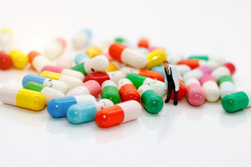 miniature people : doctor with drug using as background medical concept
